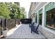 Inviting patio with a grill, outdoor seating, and view of the landscaped backyard at 8221 Houser St, Cornelius, NC 28031