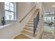 View of a staircase with wood treads, white risers, and black metal railings and lots of light at 8221 Houser St, Cornelius, NC 28031