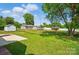 Spacious fenced backyard with large grassy area, storage shed, and deck, perfect for outdoor activities and relaxation at 8309 Emily Dr, Harrisburg, NC 28075