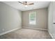 Neutral bedroom featuring carpet, a ceiling fan, and a large window at 8309 Emily Dr, Harrisburg, NC 28075