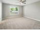 Bedroom featuring neutral carpet, a ceiling fan, and a window at 8309 Emily Dr, Harrisburg, NC 28075