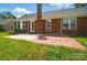 Charming brick home exterior featuring a well-maintained lawn and patio, perfect for outdoor gatherings and relaxation at 8309 Emily Dr, Harrisburg, NC 28075