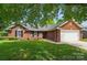 Beautiful brick home with lush lawn, trimmed shrubs, and a spacious two-car garage at 8309 Emily Dr, Harrisburg, NC 28075