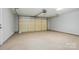 Spacious and bright garage with epoxy flooring and an insulated garage door at 8309 Emily Dr, Harrisburg, NC 28075