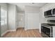 Bright kitchen featuring stainless steel appliances, white cabinets, with access to the back door at 8309 Emily Dr, Harrisburg, NC 28075