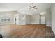 Spacious living area featuring vaulted ceilings, modern lighting, and beautiful hardwood floors at 8309 Emily Dr, Harrisburg, NC 28075