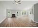 Bright, airy living room with hardwood floors, a fireplace, and plenty of natural light at 8309 Emily Dr, Harrisburg, NC 28075