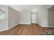 Bright living room with neutral walls, hardwood floors, and a blank canvas for decor at 8309 Emily Dr, Harrisburg, NC 28075