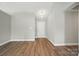 Bright living room with hardwood floors and a white front door, ready for personalization at 8309 Emily Dr, Harrisburg, NC 28075