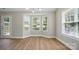 Bright sun room with hardwood floors, bay window, and access to the backyard at 8309 Emily Dr, Harrisburg, NC 28075