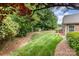 Beautiful backyard featuring lush greenery, mature trees, and a well-maintained lawn at 9013 Trellis Pointe Blvd, Charlotte, NC 28227