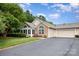 Home exterior featuring stone and siding, arched windows, and an attached two car garage at 9013 Trellis Pointe Blvd, Charlotte, NC 28227