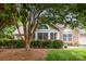 Charming home exterior featuring stone accents, manicured landscaping, and large windows at 9013 Trellis Pointe Blvd, Charlotte, NC 28227
