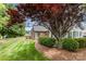 Landscaped yard with a well-maintained lawn and mature trees surrounding the home's exterior at 9013 Trellis Pointe Blvd, Charlotte, NC 28227