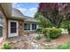 Inviting front entrance with a stone walkway, garden, and charming details at 9013 Trellis Pointe Blvd, Charlotte, NC 28227