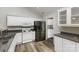 Well-lit kitchen featuring modern appliances and ample cabinet space with views to laundry room at 9013 Trellis Pointe Blvd, Charlotte, NC 28227