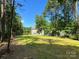 Expansive backyard featuring a lush lawn, bordered by mature trees for enhanced privacy at 9115 Providence S Rd, Waxhaw, NC 28173