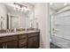 Bathroom features a double vanity with granite countertop, and a glass enclosed shower-tub combo at 9115 Providence S Rd, Waxhaw, NC 28173