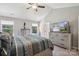 Vaulted bedroom showcasing a king bed, coordinating dressers, dual windows, and neutral tones, for a serene space at 9115 Providence S Rd, Waxhaw, NC 28173