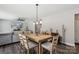 Open dining area next to living room showcasing a rustic table and modern lighting at 9115 Providence S Rd, Waxhaw, NC 28173