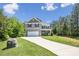 Two-story home with a well-manicured lawn, two-car garage, and inviting curb appeal at 9115 Providence S Rd, Waxhaw, NC 28173