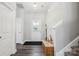 Inviting foyer with hardwood floors, coat closet, and staircase, offering a warm welcome at 9115 Providence S Rd, Waxhaw, NC 28173