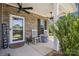 Cozy front porch with rocking chairs, brick accents, ceiling fans, and welcoming decor at 9115 Providence S Rd, Waxhaw, NC 28173