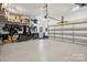 Spacious garage with epoxy flooring, overhead storage racks, and an automatic door opener, providing ample parking at 9115 Providence S Rd, Waxhaw, NC 28173