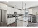 Modern kitchen featuring white cabinets, granite countertops, and stainless steel appliances at 9115 Providence S Rd, Waxhaw, NC 28173