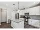 Bright kitchen features stainless appliances, gray backsplash, and an island with a granite countertop and pendant lights at 9115 Providence S Rd, Waxhaw, NC 28173