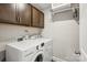 Functional laundry room features modern washer and dryer, upper cabinets, and a wire rack at 9115 Providence S Rd, Waxhaw, NC 28173