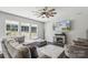 Comfortable living room with a stone fireplace, large windows, and stylish furnishings at 9115 Providence S Rd, Waxhaw, NC 28173