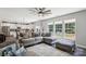 Open-concept living room with a spacious sectional sofa and view of the backyard at 9115 Providence S Rd, Waxhaw, NC 28173