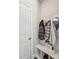 Mudroom with storage bench, coat hooks, and a nearby door, offering a convenient transition from outdoors to the home at 9115 Providence S Rd, Waxhaw, NC 28173