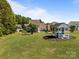 Expansive backyard with lush lawn, playground, and surrounding homes, perfect for Gathering activities and outdoor enjoyment at 9871 Travertine Trl, Davidson, NC 28036