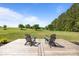 Tranquil backyard deck with two lounge chairs overlooking the lush green grass at 9871 Travertine Trl, Davidson, NC 28036