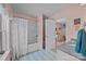Bright bathroom featuring a tub/shower combo, granite countertop vanity, and colorful decor at 9871 Travertine Trl, Davidson, NC 28036