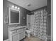 The bathroom features neutral paint, a shower-tub combo, and a vanity with granite counters at 9871 Travertine Trl, Davidson, NC 28036