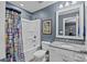 Cozy bathroom with shower, toilet, framed art, and modern vanity with granite countertops at 9871 Travertine Trl, Davidson, NC 28036