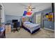 Bedroom featuring carpet, ceiling fan, natural light, and a desk at 9871 Travertine Trl, Davidson, NC 28036