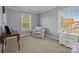 This seating area features a bright window, neutral paint, and offers a relaxing respite at 9871 Travertine Trl, Davidson, NC 28036