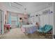 Adorable bedroom with a pink bed, a desk, a chandelier, and polka dot accents at 9871 Travertine Trl, Davidson, NC 28036