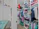 The closet has organized shelving, a closet rod with clothing, and is carpeted for comfort at 9871 Travertine Trl, Davidson, NC 28036