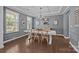 Bright dining room with coffered ceilings, hardwood floors and elegant chandelier at 9871 Travertine Trl, Davidson, NC 28036