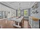 Bright dining room with hardwood floors, coffered ceiling and wainscoting at 9871 Travertine Trl, Davidson, NC 28036
