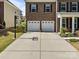 Spacious driveway leading to a two-car garage, complete with basketball hoop at 9871 Travertine Trl, Davidson, NC 28036