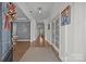 Welcoming foyer with hardwood floors, elegant trim and decorative accents, leads to living area at 9871 Travertine Trl, Davidson, NC 28036