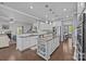 Modern kitchen featuring a large island, stainless steel appliances, and an open layout at 9871 Travertine Trl, Davidson, NC 28036