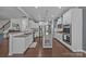 Bright kitchen with white cabinets, granite countertops, stainless appliances, and hardwood floors at 9871 Travertine Trl, Davidson, NC 28036