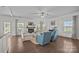 Cozy living room featuring hardwood floors, a fireplace, and comfortable seating at 9871 Travertine Trl, Davidson, NC 28036
